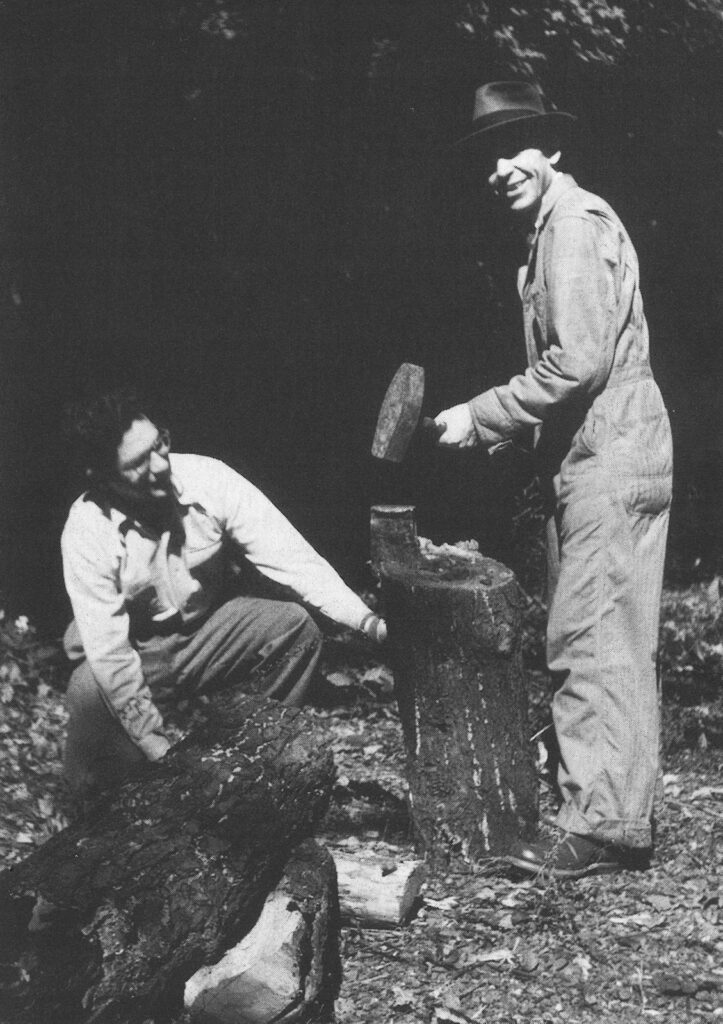 Two men splitting wood