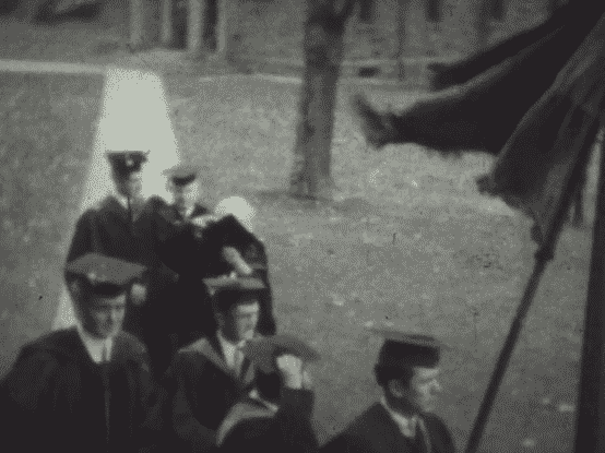 old video footage of a commencement procession featuring Marie Curie