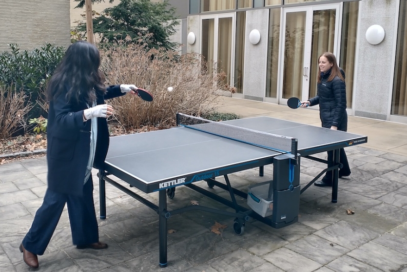 Two Science History Institute staff play ping pong in the courtyard of the building