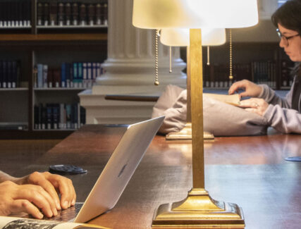 scholars doing research in a library