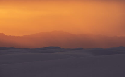 Landscape photo of orange sky over sand dunes