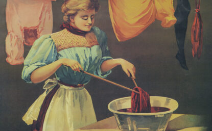 woman in apron dyeing cloth in a basin
