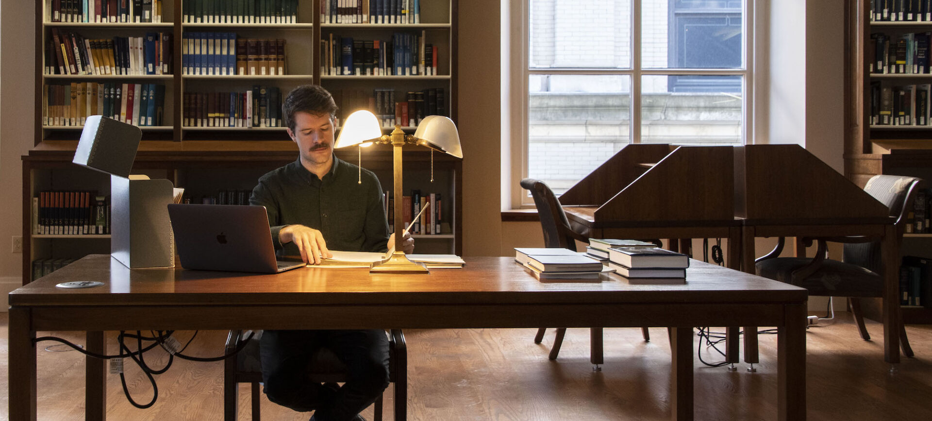 man doing research in a library