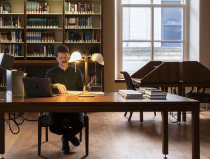 man doing research in a library