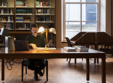 man doing research in a library