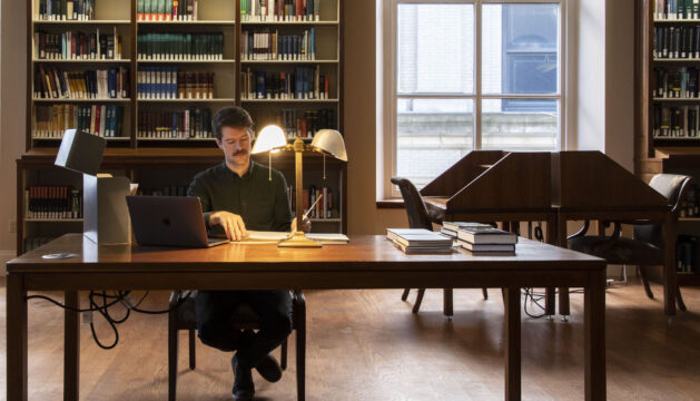 man doing research in a library