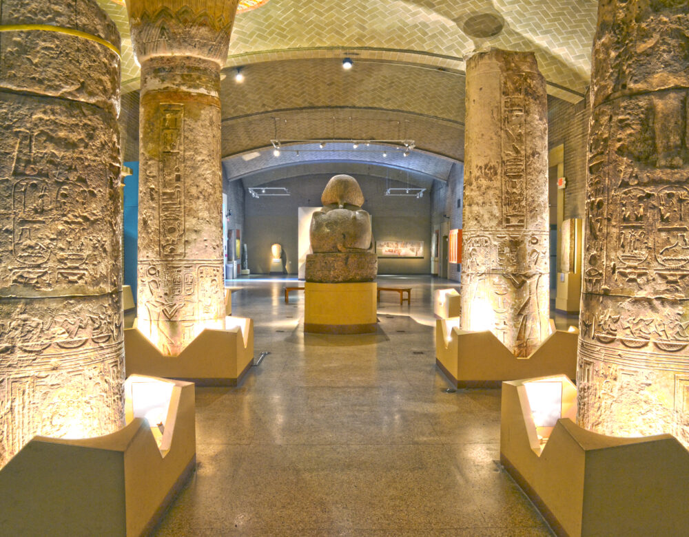 Egyptian palace at the Penn Museum, looking through columns toward the back of a statue