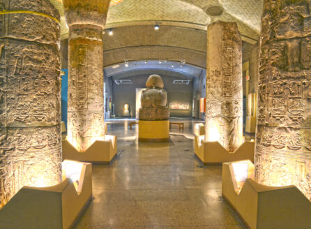 Egyptian palace at the Penn Museum, looking through columns toward the back of a statue