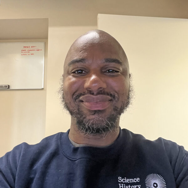 Tyree smiling, wearing navy blue shirt with Science History Institute logo