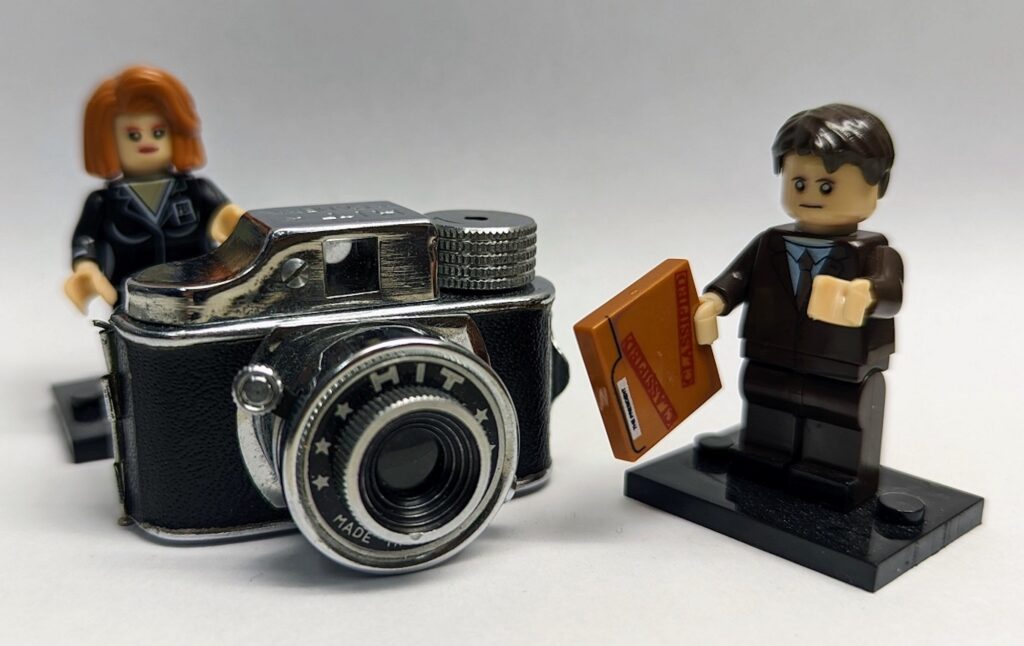 tiny camera pictured with lego people to show scale