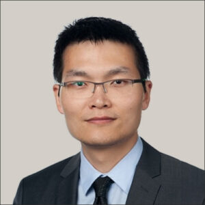 Nian Liu wearing glasses, suit, and tie