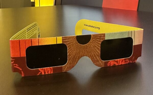 colorful pair of eclipse glasses on a table in the museum gallery