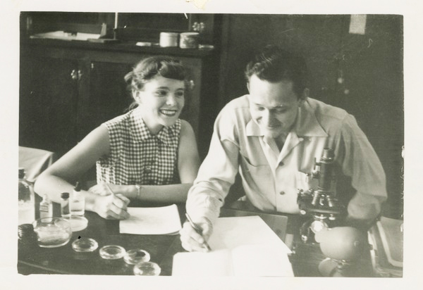 old photo of woman and man at a lab bench