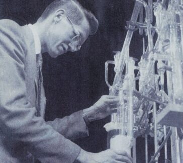 black and white photo of a man in a lab