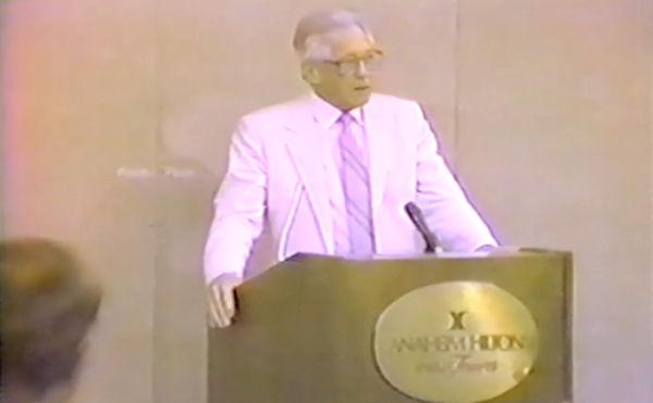man giving a speech at a podium