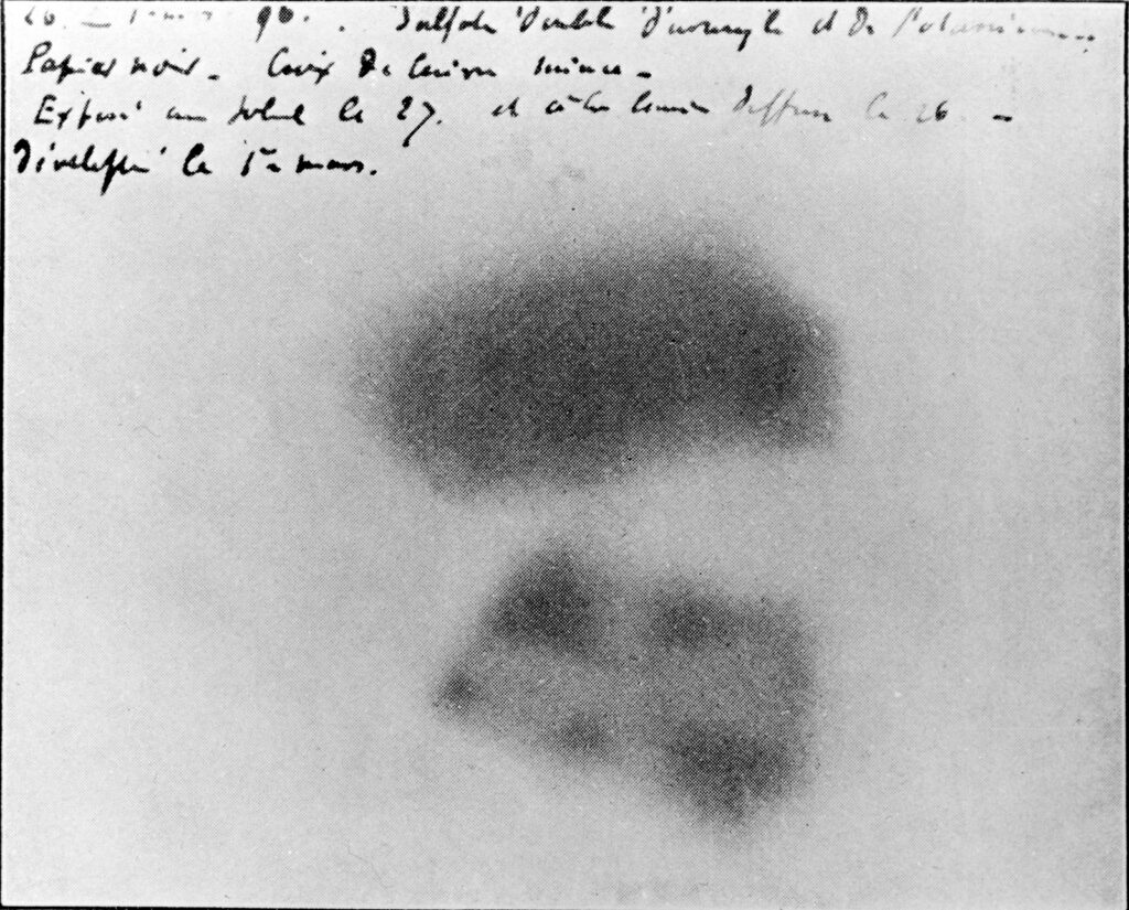 Blurry black and white image of blobs with handwriting