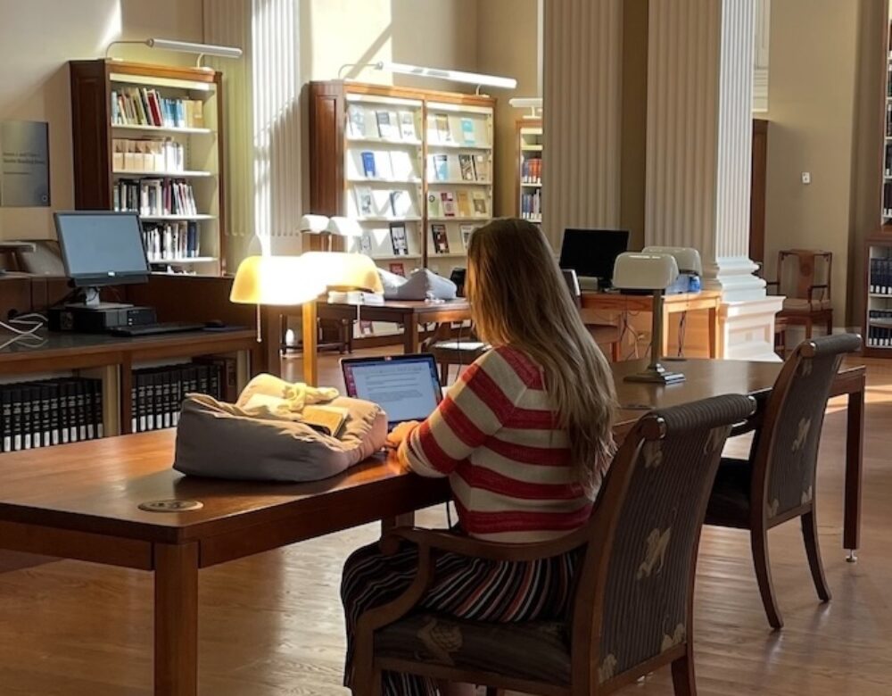 person doing research in a library