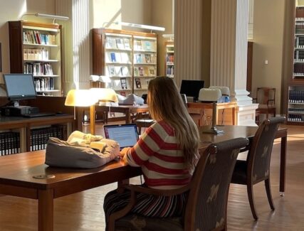 person doing research in a library