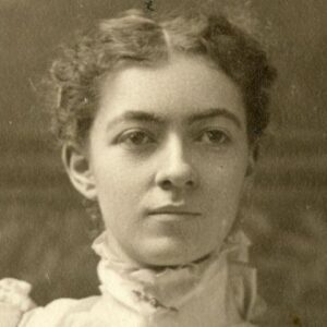 b/w photo of a women seated in a dress
