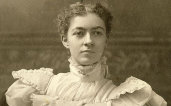 b/w photo of a women seated in a dress