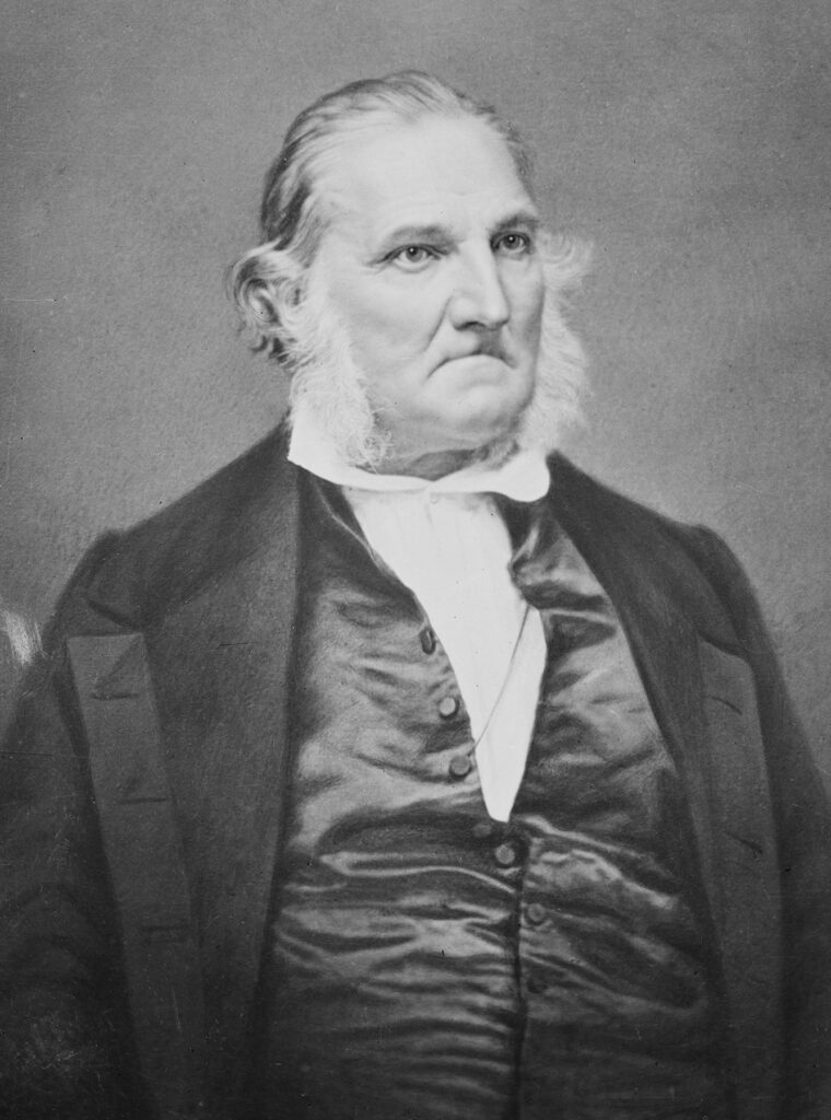 Black and white portrait of an old man in suit