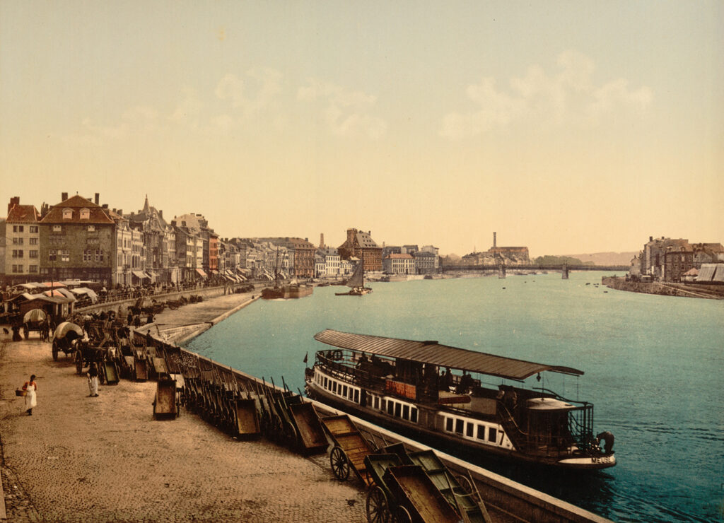 Colored photograph of a city quay and river scene