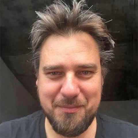 man in a black shirt over dark background