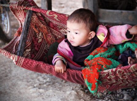 infant in a colorful cradle