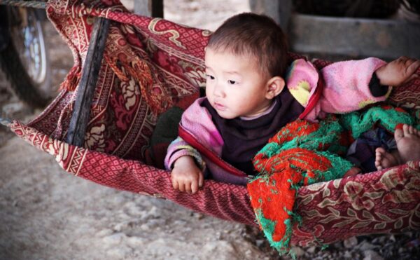 infant in a colorful cradle