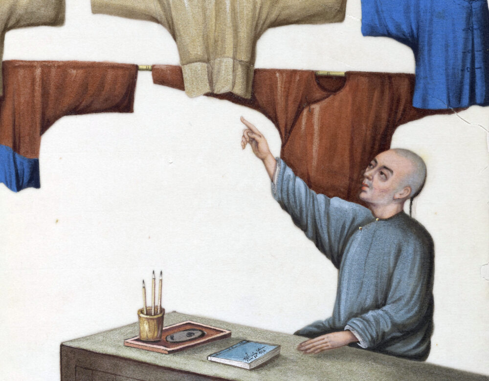 illustration of man pointing to hanging dyed clothes