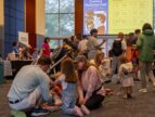 kids and parents sitting on the floor