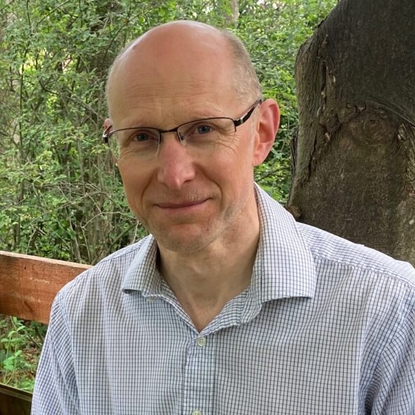 photo of a bald man wearing glasses