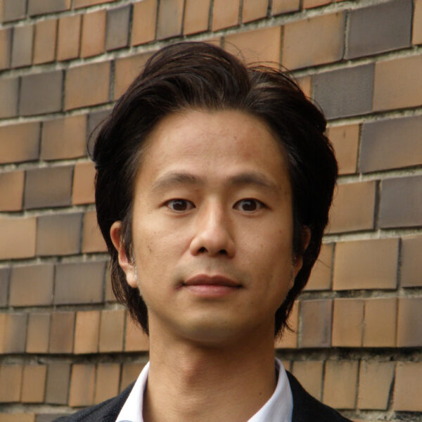 Man in front of brick wall