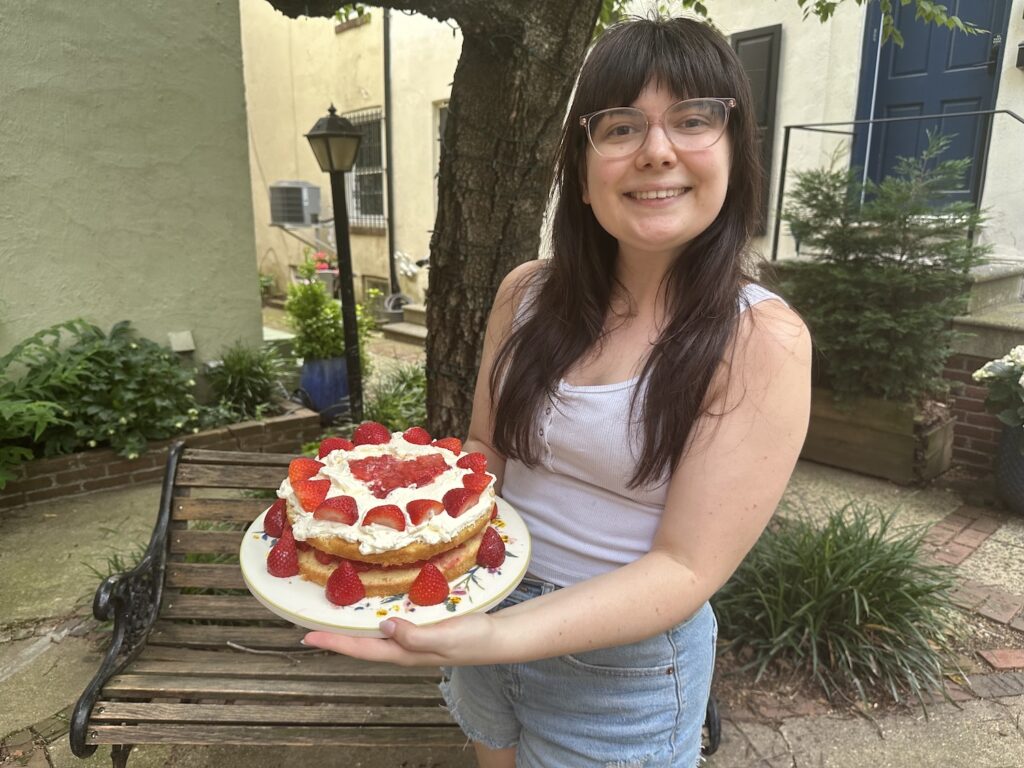 photo of a woman holding a cake