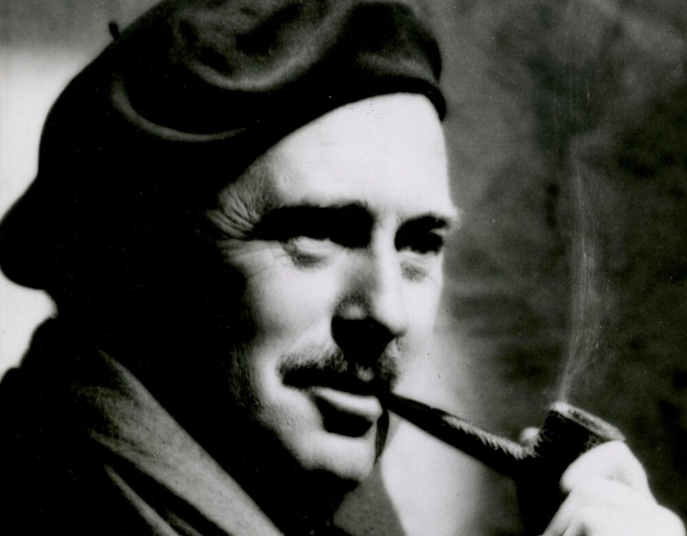 man in a hat smoking a pipe