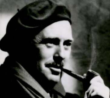 man in a hat smoking a pipe