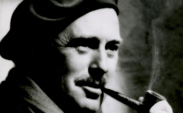 man in a hat smoking a pipe