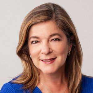 studio portrait of Phoebe Miles wearing blue