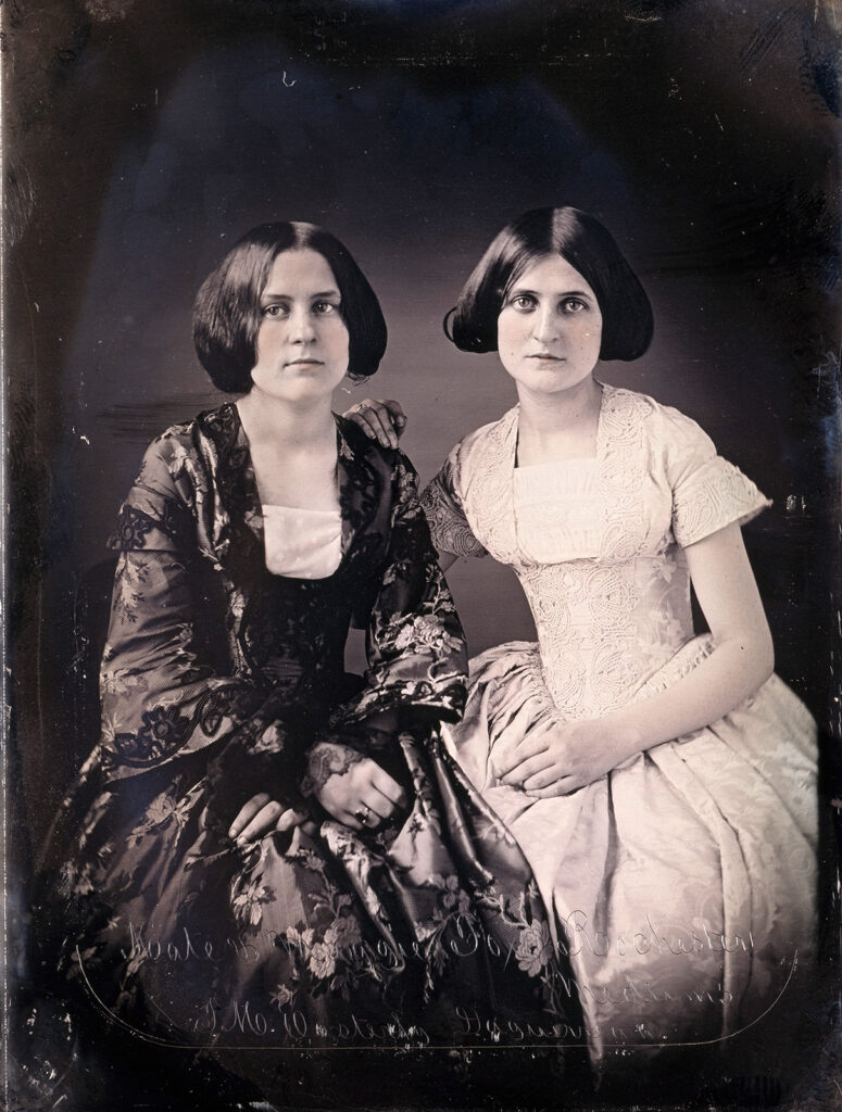 Daguerreotype of two well-dressed young women seated
