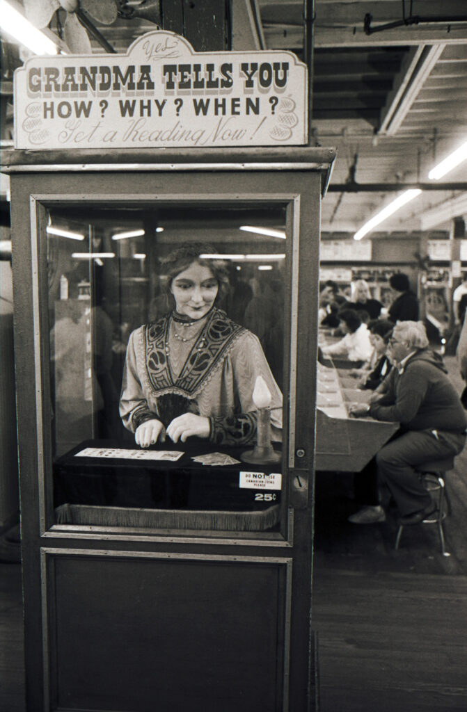 Black and white photo of a machine featuring an animatronic old woman