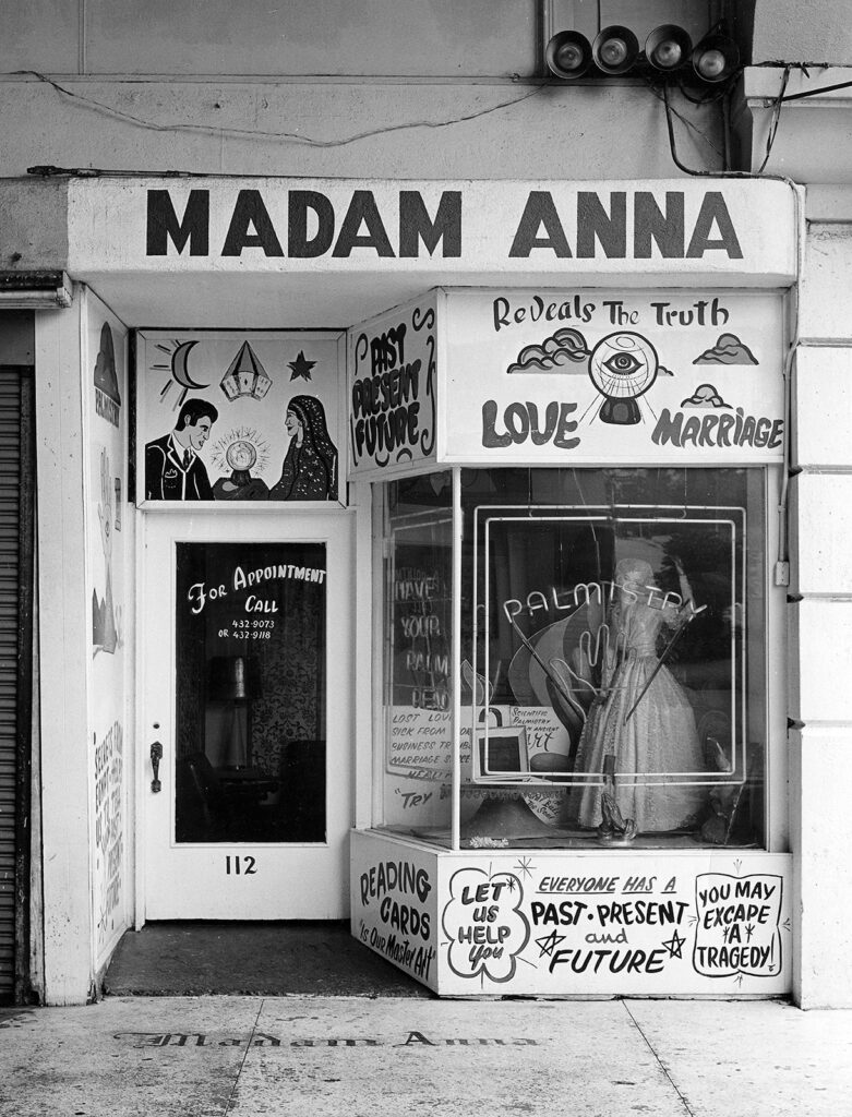 Storefront advertising fortune-telling services, such as palm reading.