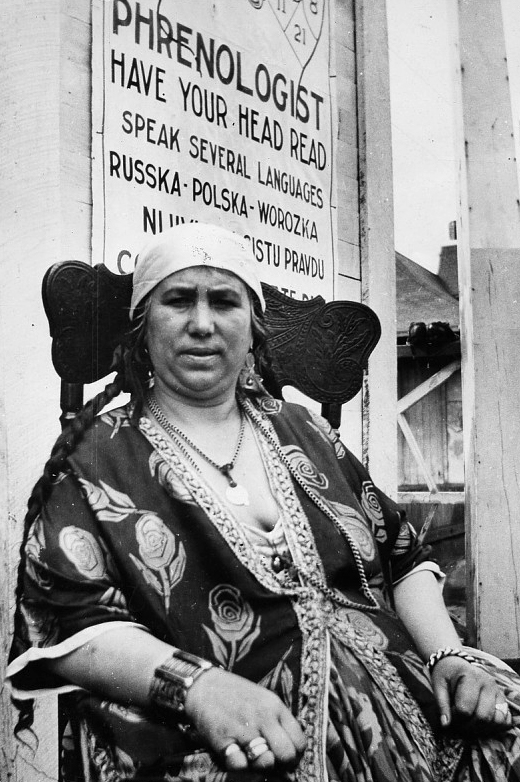 Black and white photo of an older women offering phrenology