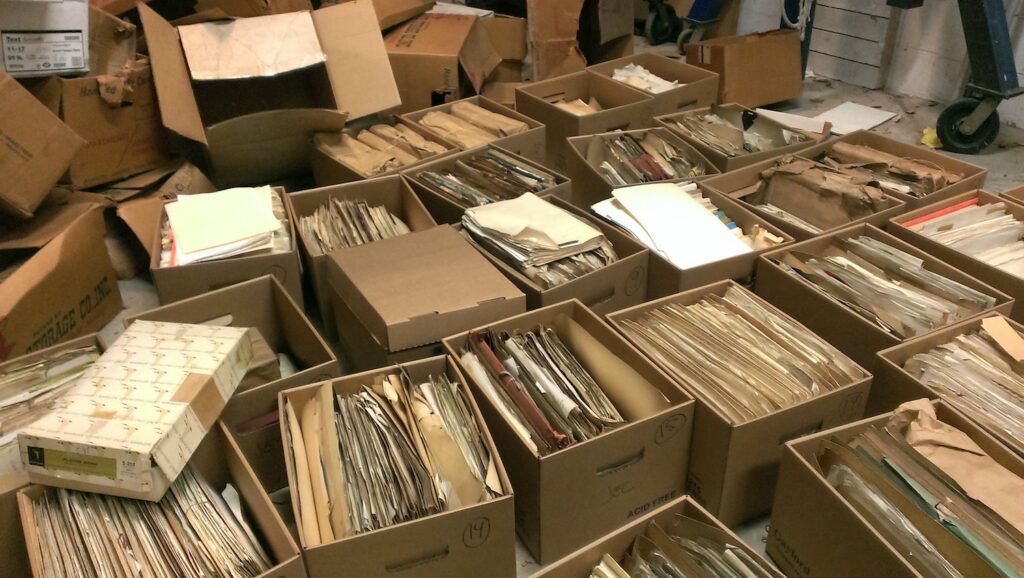 photo of archival boxes filled with papers and files