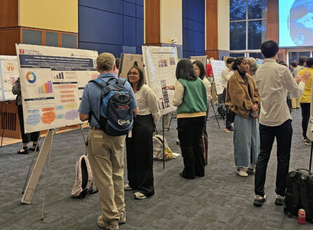 gathering of people interacting with science posters