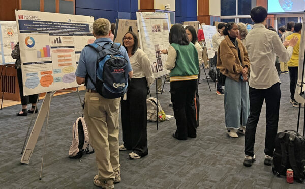 gathering of people interacting with science posters