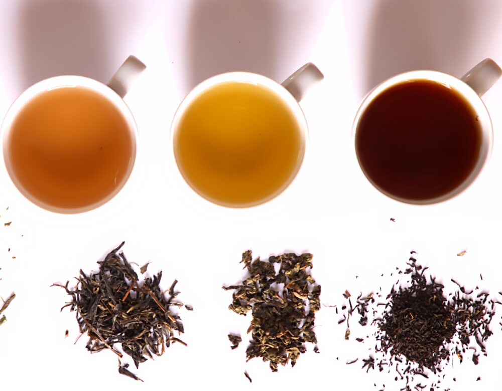 overhead view of cups of tea and tea leaves