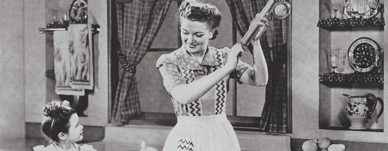 woman holding am insect sprayer while a child looks on