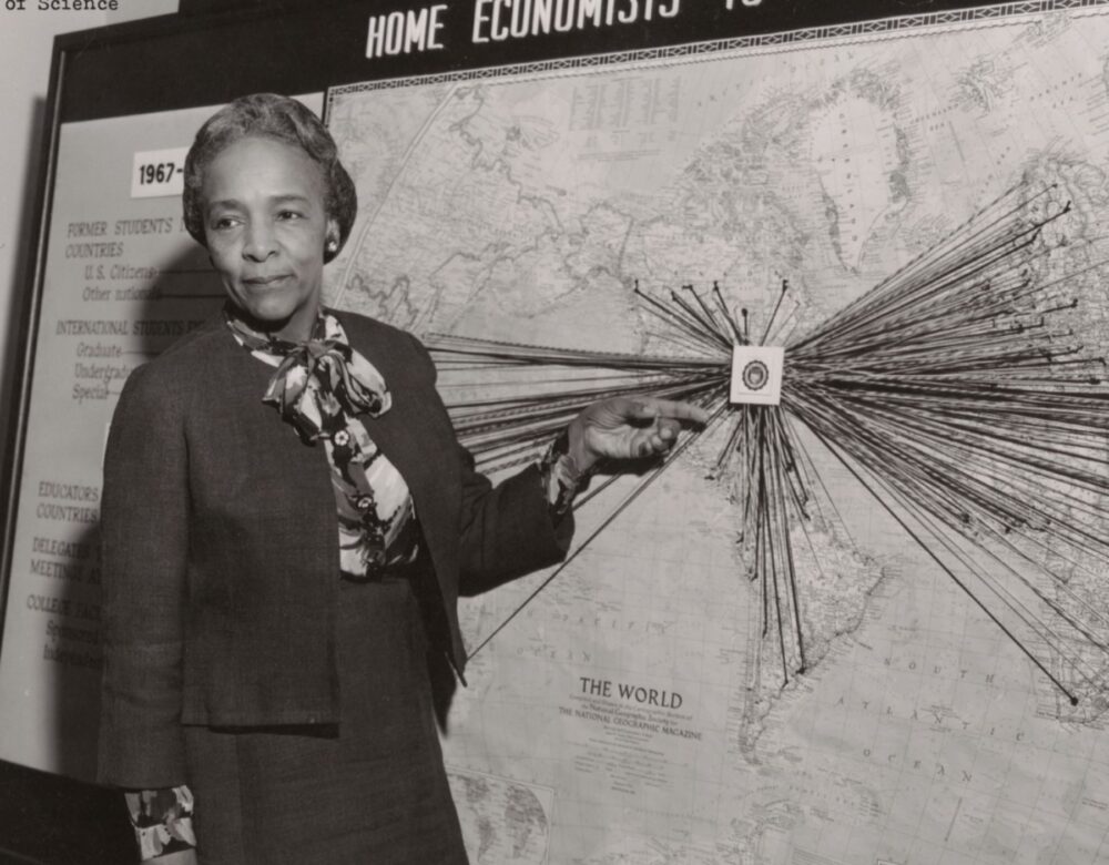 Flemmie Kittrell demonstrates something at a board.