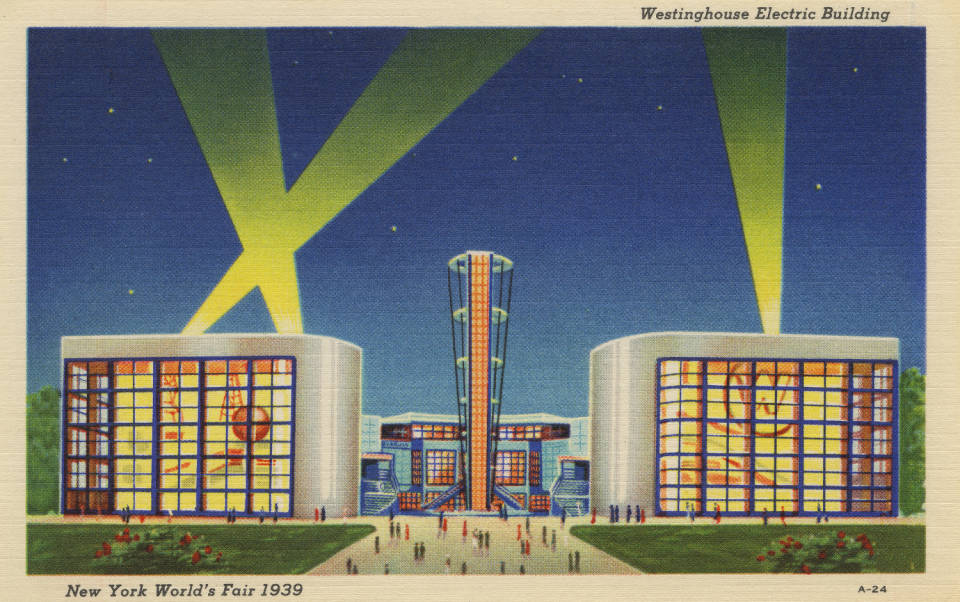 A color postcard showing a brightly lit building at night