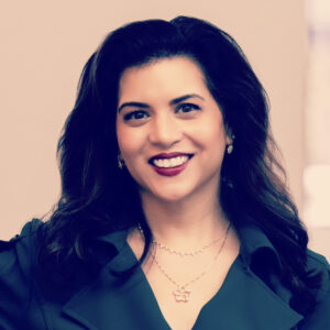 portrait of a woman, smiling, wearing dark green